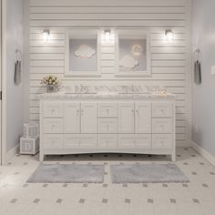 a large white bathroom with two sinks and mirrors