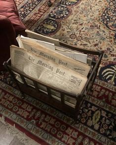 newspapers are stacked on top of an old wooden crate