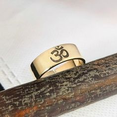 About Item  Item           :- Om Engrave Ring Ring size   :- Choose from variation( Custom size accepted) Material   :- 92.5 sterling silver & Brass ( Choose from variation ) Item Title :- Solid Gold Om Ring, Handmade Ring, Silver OM Ring, Buddhist Ring, Meditation Ring, Symbolic Ring, Ohm Ring, Yoga Jewelry, Dainty Gift ring Description:- We use 925 sterling silver & 14K pure gold to making jewelry. We accept all types of custom & personalized order. Please send us a message if you are interested in a custom creation.  Shipping profile :- We ship all order within 3-5 days. But custom order takes time. Customer service:- If you have any question about our products & services, feel free to contact us. We do always best for our customers. Thanks & Regards, HandmadejeweleryCo. Adjustable Engraved Spiritual Ring, Handmade Symbolic Open Ring, Symbolic Handmade Open Engraved Ring, Symbolic Handmade Engraved Open Ring, Handmade Symbolic Engraved Ring For Promise, Symbolic Handmade Engraved Promise Ring, Symbolic Handmade Midi Rings Gift, Handmade Symbolic Promise Rings, Handmade Spiritual Rings For Promise