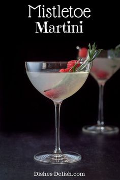 two martini glasses with raspberries and rosemary garnish on the rims