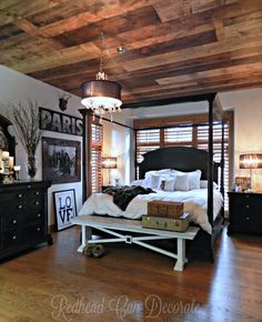 a bedroom with a bed, dresser and pictures on the wall