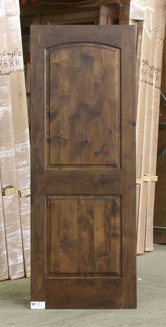 a large wooden door sitting inside of a warehouse