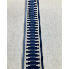 a blue and white train track on fabric