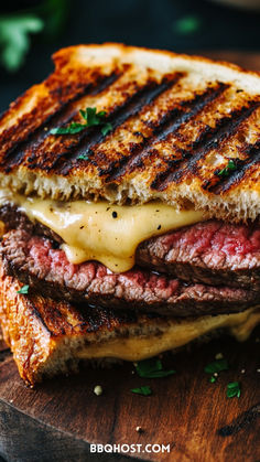 a grilled cheeseburger is shown on a cutting board