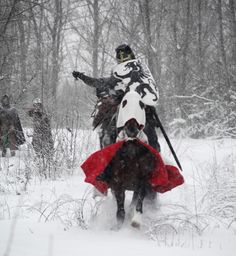 a man riding on the back of a horse in the snow