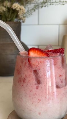 there is a strawberry milkshake with strawberries in it