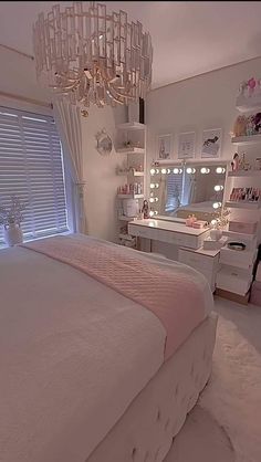 a bedroom with a chandelier hanging from the ceiling