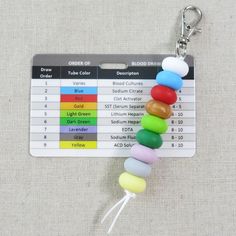 a keychain with a bunch of beads attached to it's back side