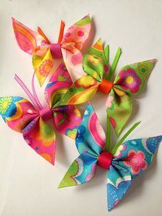 three different colored bows on a white surface