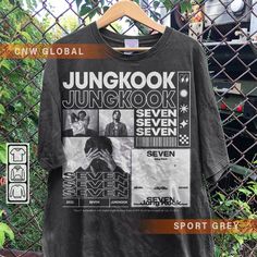 a t - shirt hanging on a fence with the wordsjunnkook, seven seven seven