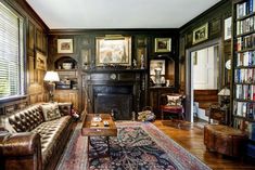 a living room filled with furniture and bookshelves next to a fire place in a fireplace