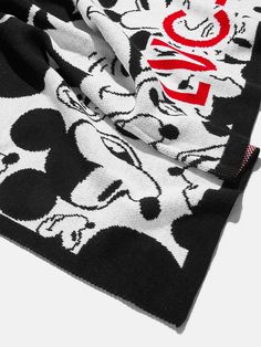 the mickey mouse sweater is black and white with red letters on it's chest