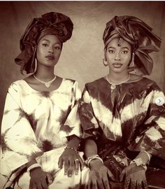 two african women in traditional clothing sitting next to each other