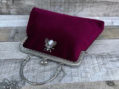 Stunning, handmade, burgundy velvet purse bag with pearl bee detail. The lining is made with a beautiful cotton fabric. Use it as a classic clutch or attach the shoulder strap to wear over your shoulder or as a crossbody - Silver colour Chain strap (detachable) - Silver colour Metal Top handle ( not detachable) - H:19cm x W:29cm x D:4cm approximately - Metal clasp: H:6.5cm x W:20cm - Top handle: H:8.5cm The pattern of the lining inside of the bag may vary. But don't worry, I always make sure the Elegant Velvet Evening Bag For Wedding, Velvet Rectangular Evening Bag For Wedding, Velvet Clutch For Wedding, Elegant Velvet Evening Bag As Gift, Elegant Velvet Evening Bag For Gift, Elegant Velvet Evening Bag Gift, Velvet Clutch Evening Bag For Wedding, Burgundy Clutch Evening Bag For Formal Occasions, Rectangular Velvet Wedding Bag