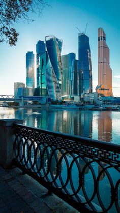 there is a view of some very tall buildings in the city from across the water