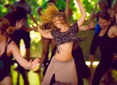 a group of young women dancing and having fun