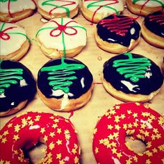 many decorated doughnuts are on display in a box