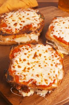 three pieces of pizza sitting on top of a wooden cutting board