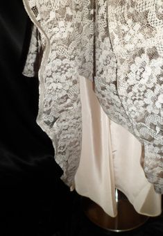 "This dress is virtually pristine, I couldn't find a single issue with it! The dress has a sheer net scalloped neckline, lace bust and body over an off white taffeta lining. The belt is lace, matches the dress, belt loops still intact. There is a metal zipper under the left arm, slides easily. The bust measures 36\". waist is 28\", hips are 52\", length is 47\", sleeves are 6\" long and the arm openings are 12\". Just a fabulous testament to the beautiful ladies of the era, could possibly even b Tea Length Scalloped Lace Dress, Scalloped Lace Tea-length Dress, Lace Dress For Evening, Evening Lace Dress With Lace Collar, Elegant Vintage Dress With Lace Trim, Fitted Contrast Lace Wedding Dress, Fitted Lace Dress With Contrast Lace For Wedding, Tea Length Lace Trim Wedding Dress, Fitted Tea-length Lace Dress With Lace Trim