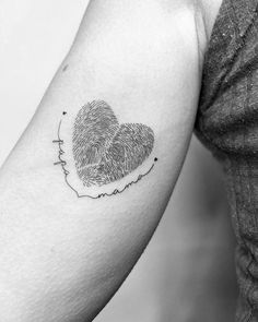 two fingerprints in the shape of a heart tattoo on the left upper arm