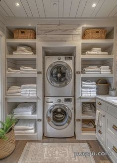 a washer and dryer in a room with lots of white linen on the shelves