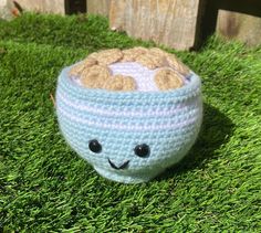 a crocheted stuffed animal sitting in the grass