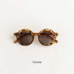 These vintage round sunnies are the perfect way to add a pop of style and fun to any outfit! - Approximately 18 months - 8 years old - 5" face/frame width x 5.5" leg/side length - UV400 protection Adjustable Round Frame Sunglasses, Adjustable Round Frame Sunglasses For Beach, Adjustable Round Frame Tinted Sunglasses, Retro Round Sunglasses For The Beach, Retro Round Sunglasses For Beach, Adjustable Retro Sunglasses For The Beach, Brown Round Sunglasses For Summer, Retro Adjustable Sunglasses For Summer, Summer Round Sunglasses With Polarized Lenses