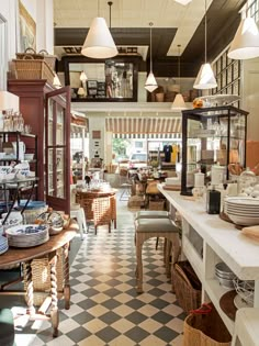 the inside of a restaurant with lots of tables and chairs