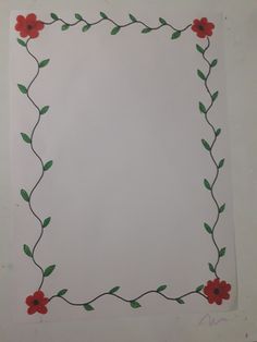 a piece of paper with red flowers and green leaves in the middle, on top of a white surface