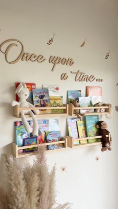 there is a shelf with books and stuffed animals on it