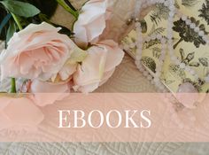 pink flowers are sitting on top of a quilt with the words ebooks above it