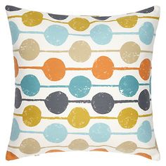 an orange, blue and yellow pillow with circles on it