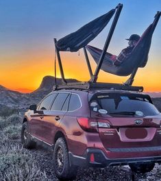 a man sitting in a hammock on top of a vehicle