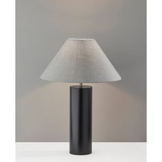 a black table lamp with a white shade on the base and a grey linen lampshade