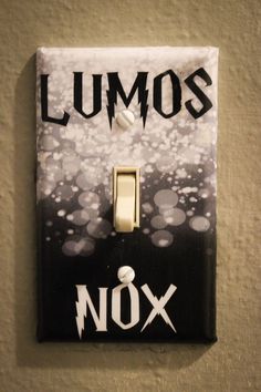 a black and white light switch cover with the words lumos nox on it