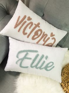 two pillows that say victoria's and ellie on them, sitting on a couch