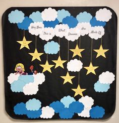 a bulletin board with stars and clouds on it