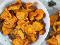 two white bowls filled with cooked sweet potato chips