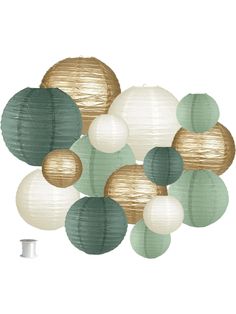 paper lanterns are hanging from the ceiling in front of a white wall with green and gold circles