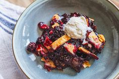 a blue plate topped with fruit and ice cream