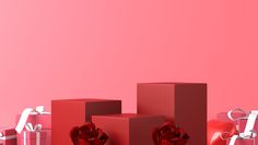 red boxes with hearts and bows on them against a bright pink background for valentine's day