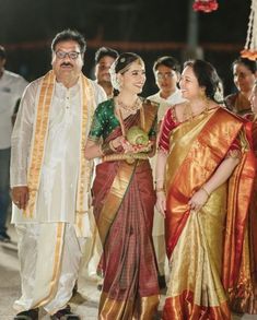 two women in sari standing next to each other