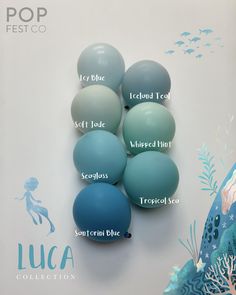 a group of blue and green balls sitting on top of each other