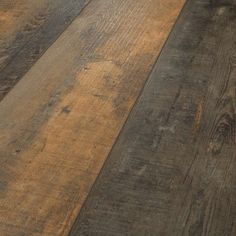 an old wood floor with brown and tan tones