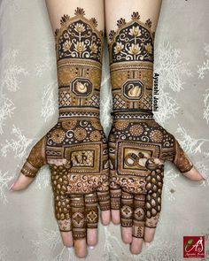 two hands with henna designs on them