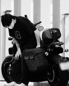 a man sitting on the back of a motorcycle