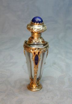 a blue and gold vase sitting on top of a table