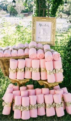 pink candles are stacked on top of each other in front of a sign that says welcome