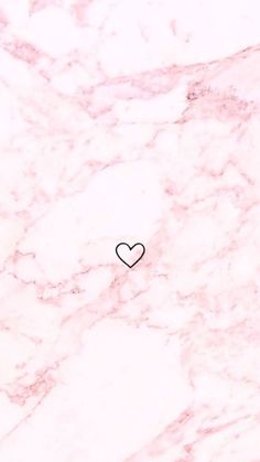 a black heart on a pink marble surface