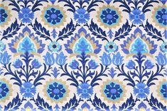 a blue and beige floral pattern on fabric